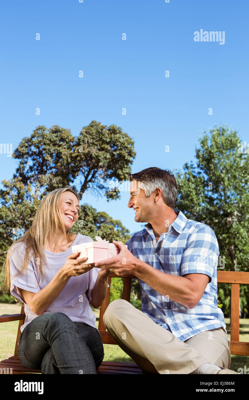 Couple relaxing in the park on bench Stock Photo - Alamy