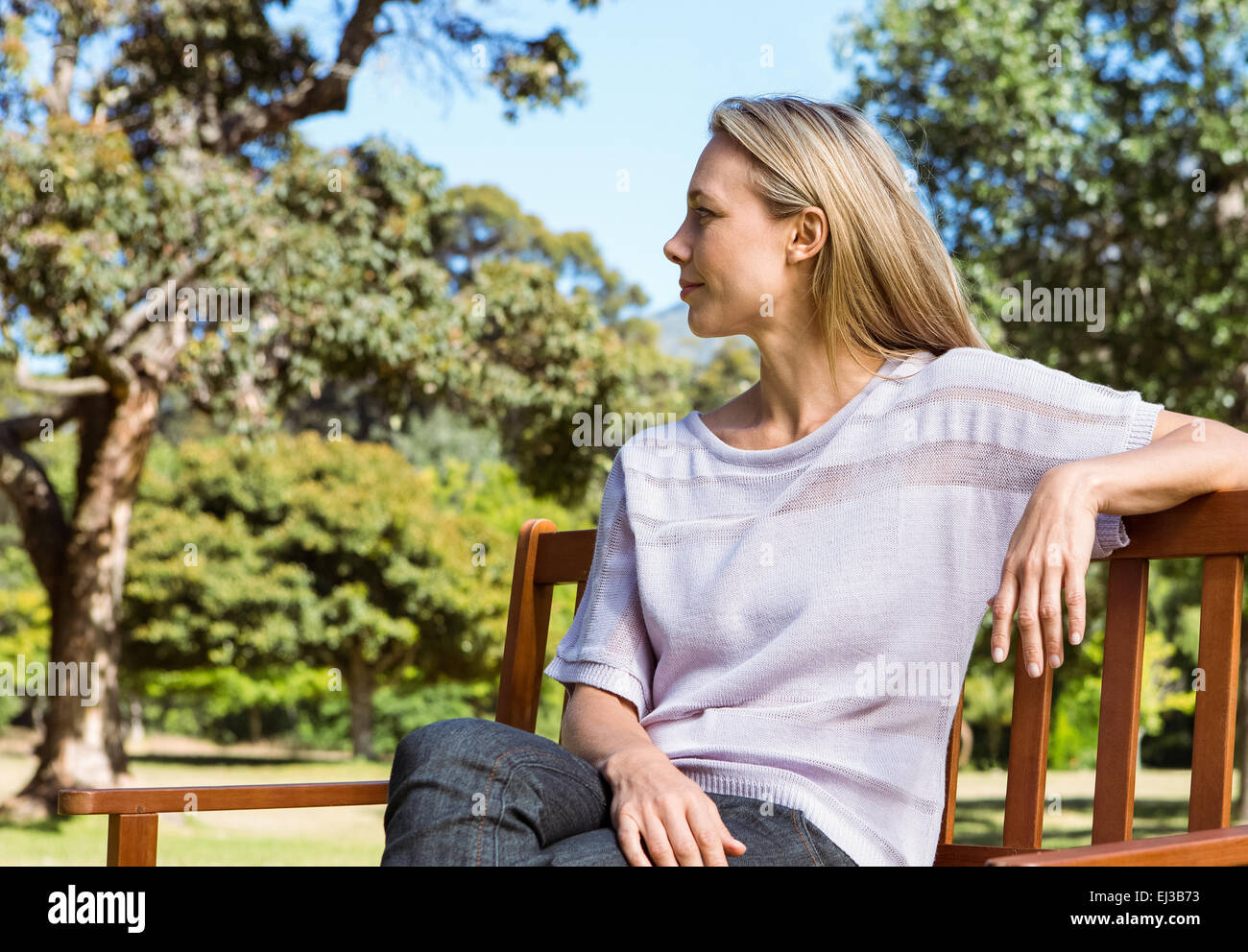 Pretty blonde relaxing in the park Stock Photo - Alamy