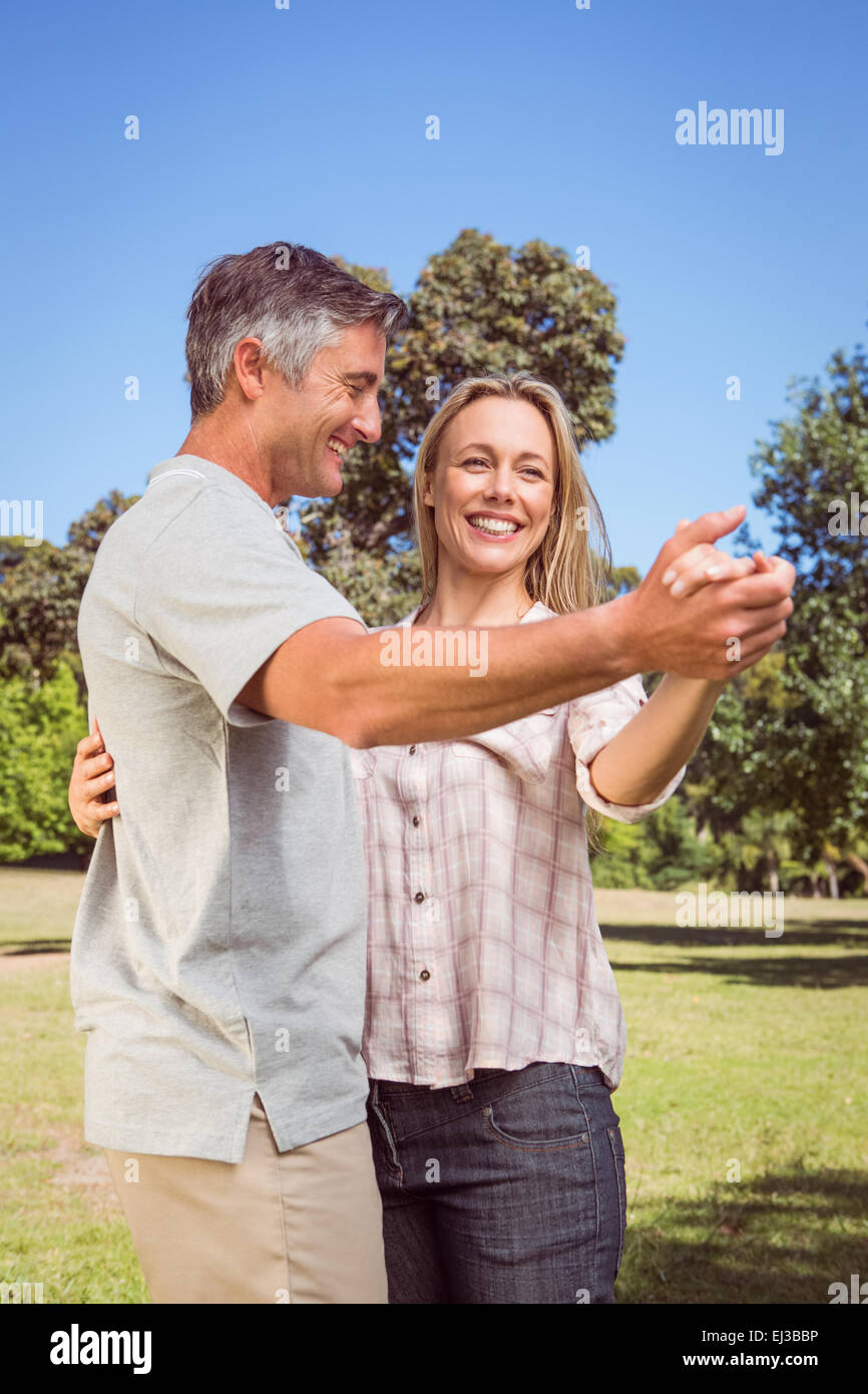 Happy couple dancing in the park Stock Photo - Alamy
