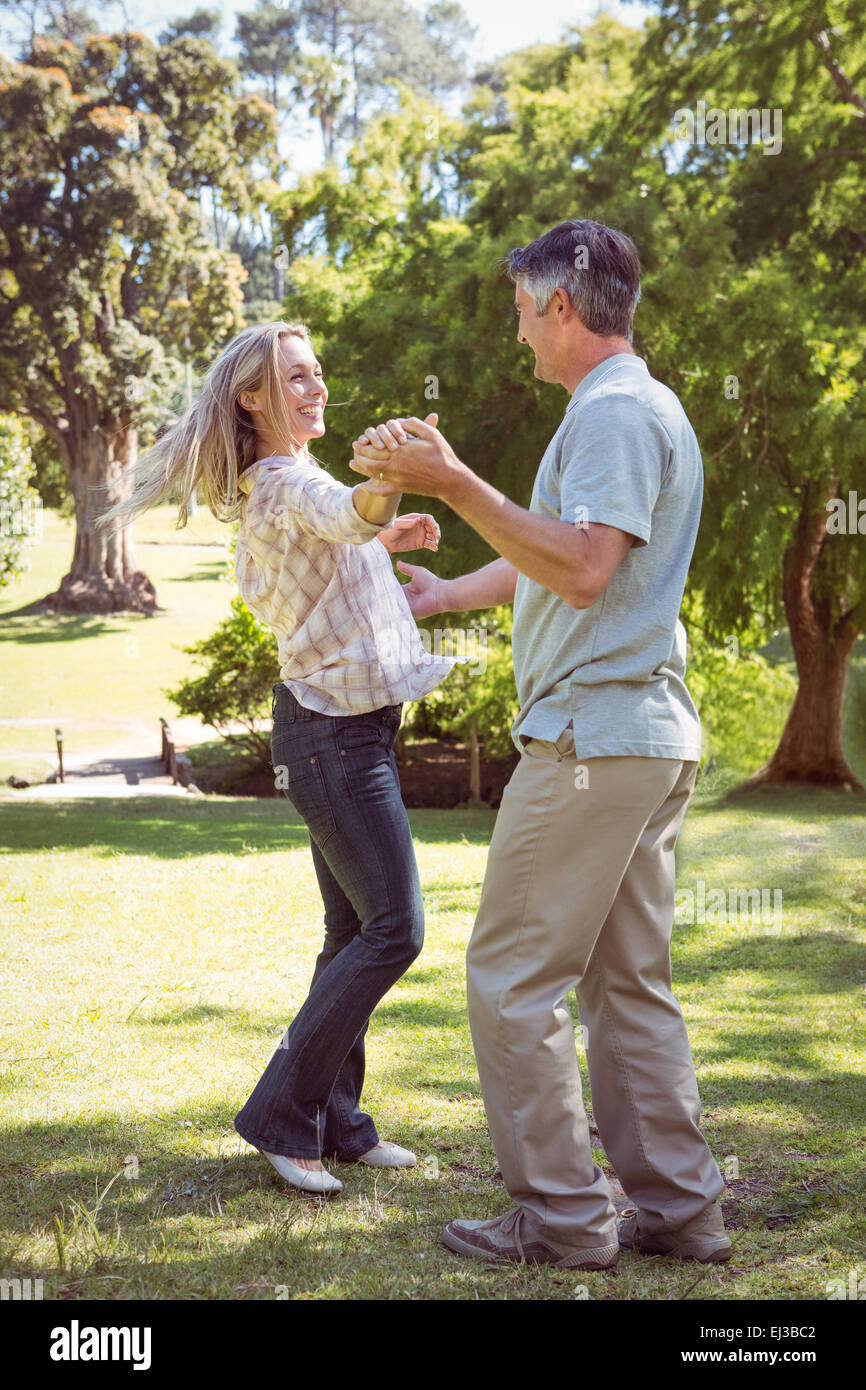 Happy couple dancing in the park Stock Photo