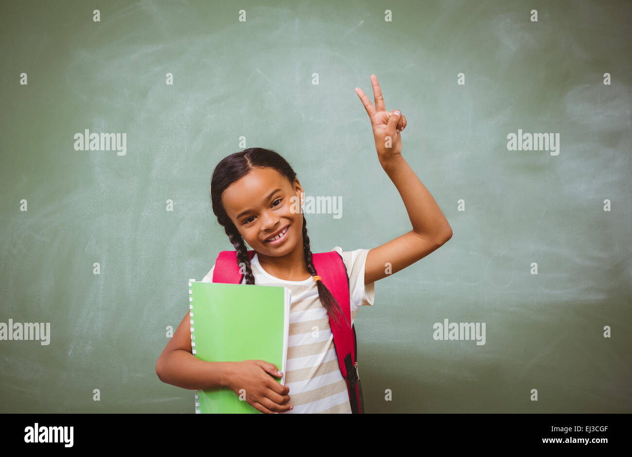 Portrait of cute little girl holding book Stock Photo - Alamy