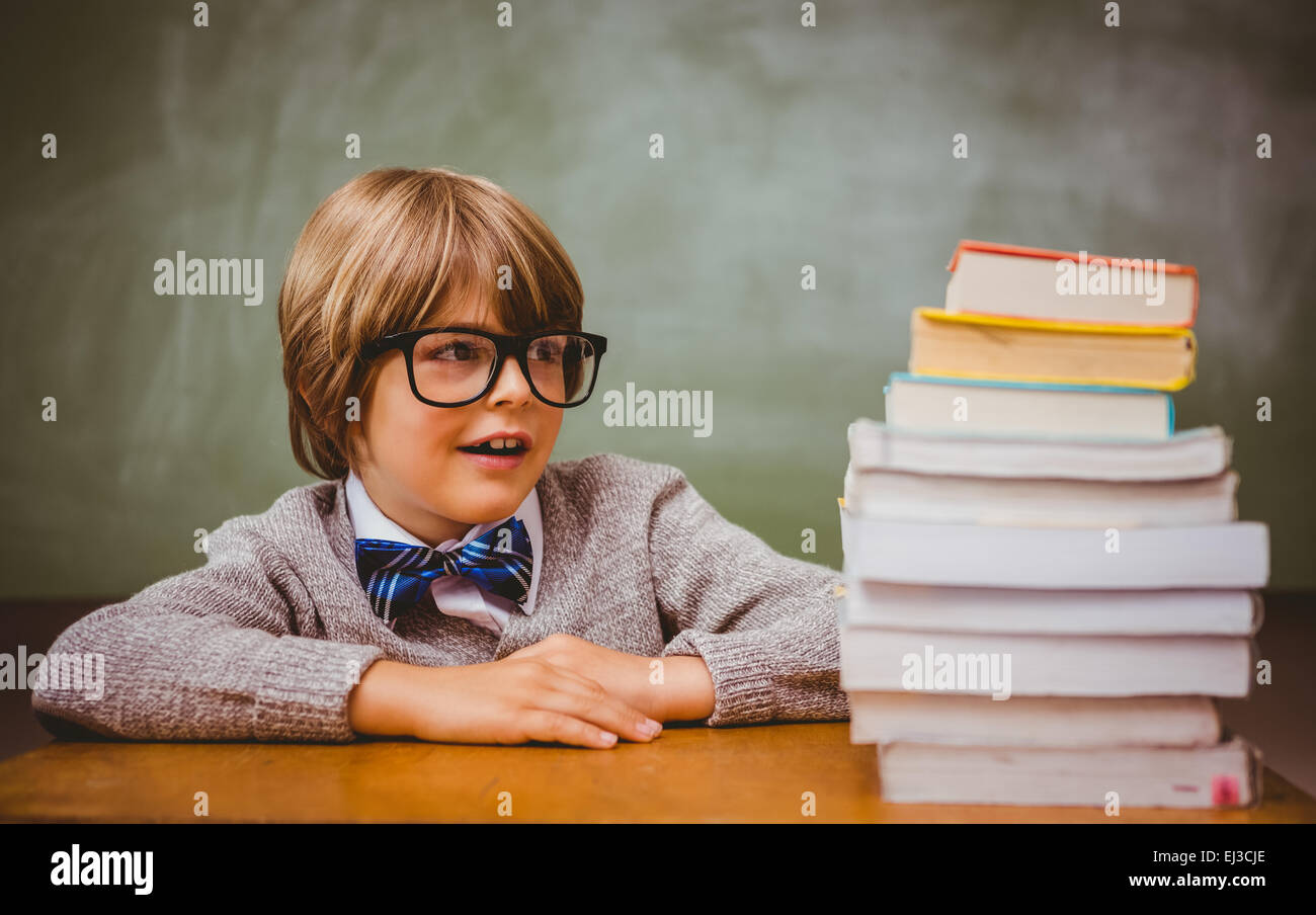 Boy with stack of books in classroom Stock Photo - Alamy