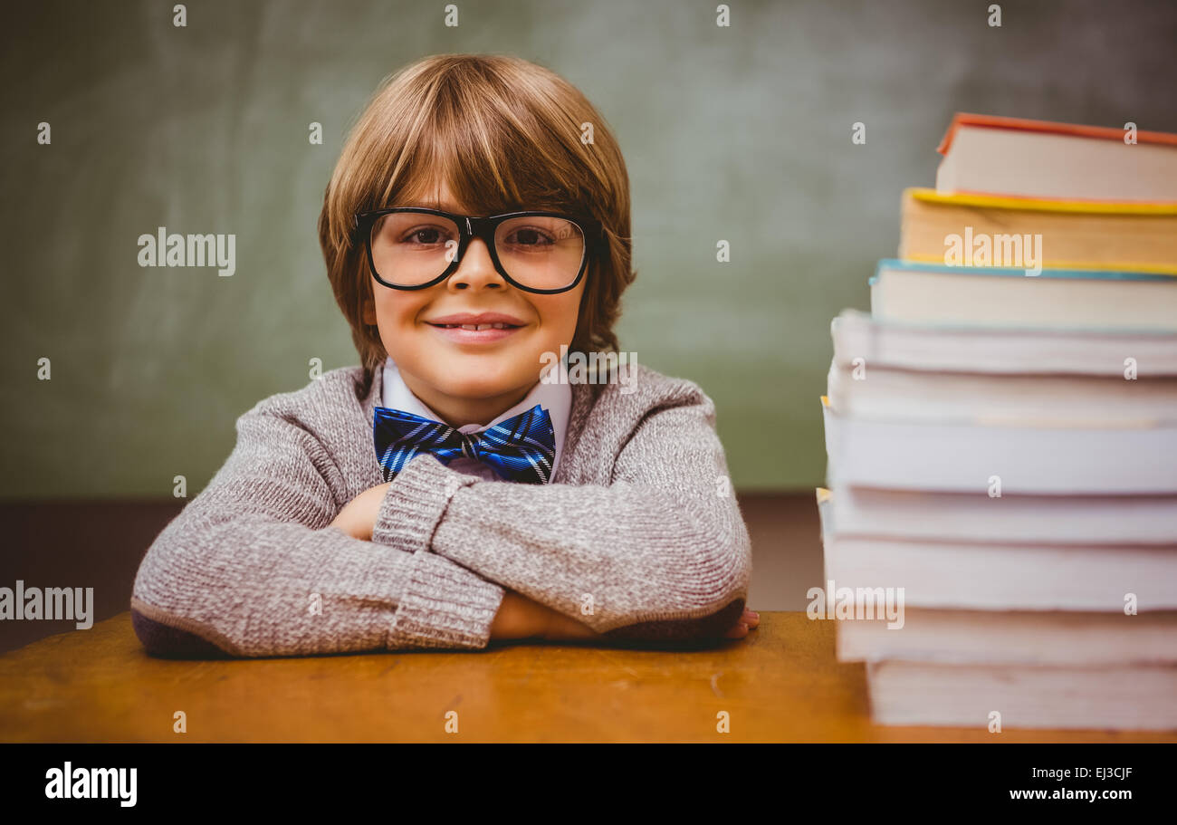 Boy with stack of books in classroom Stock Photo - Alamy