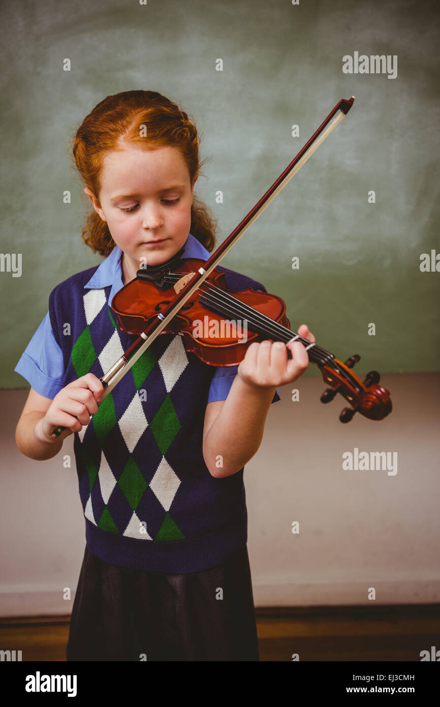 Cute little girl playing violin in classroom Stock Photo - Alamy
