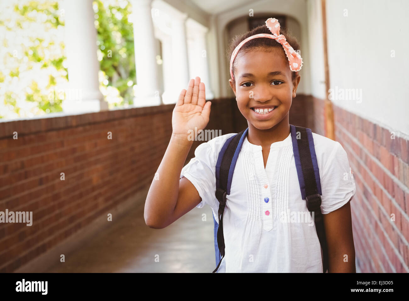 Little girl smiling in school corridor Stock Photo - Alamy