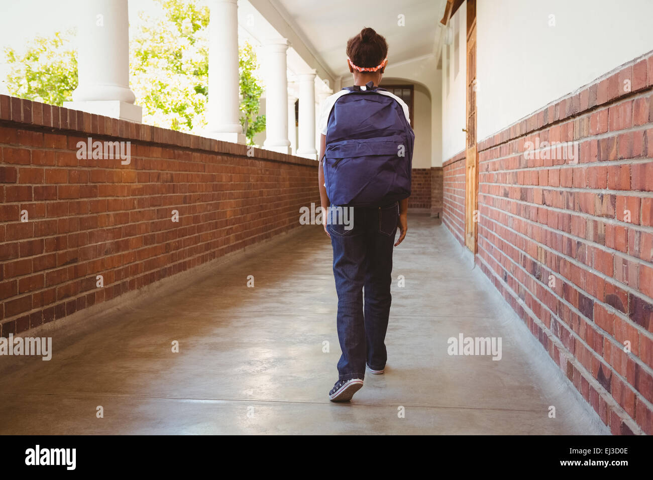 Girl walking in school corridor Stock Photo Alamy