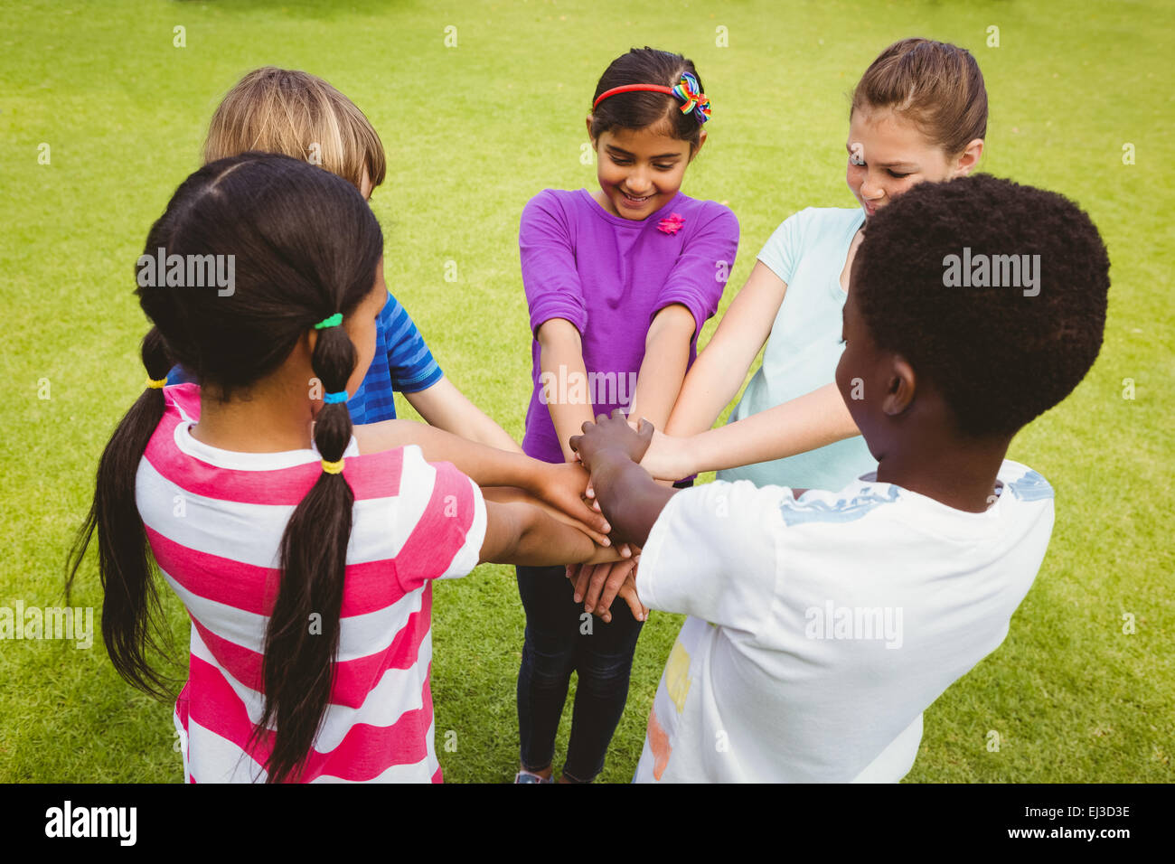 Children holding hands together at park Stock Photo - Alamy