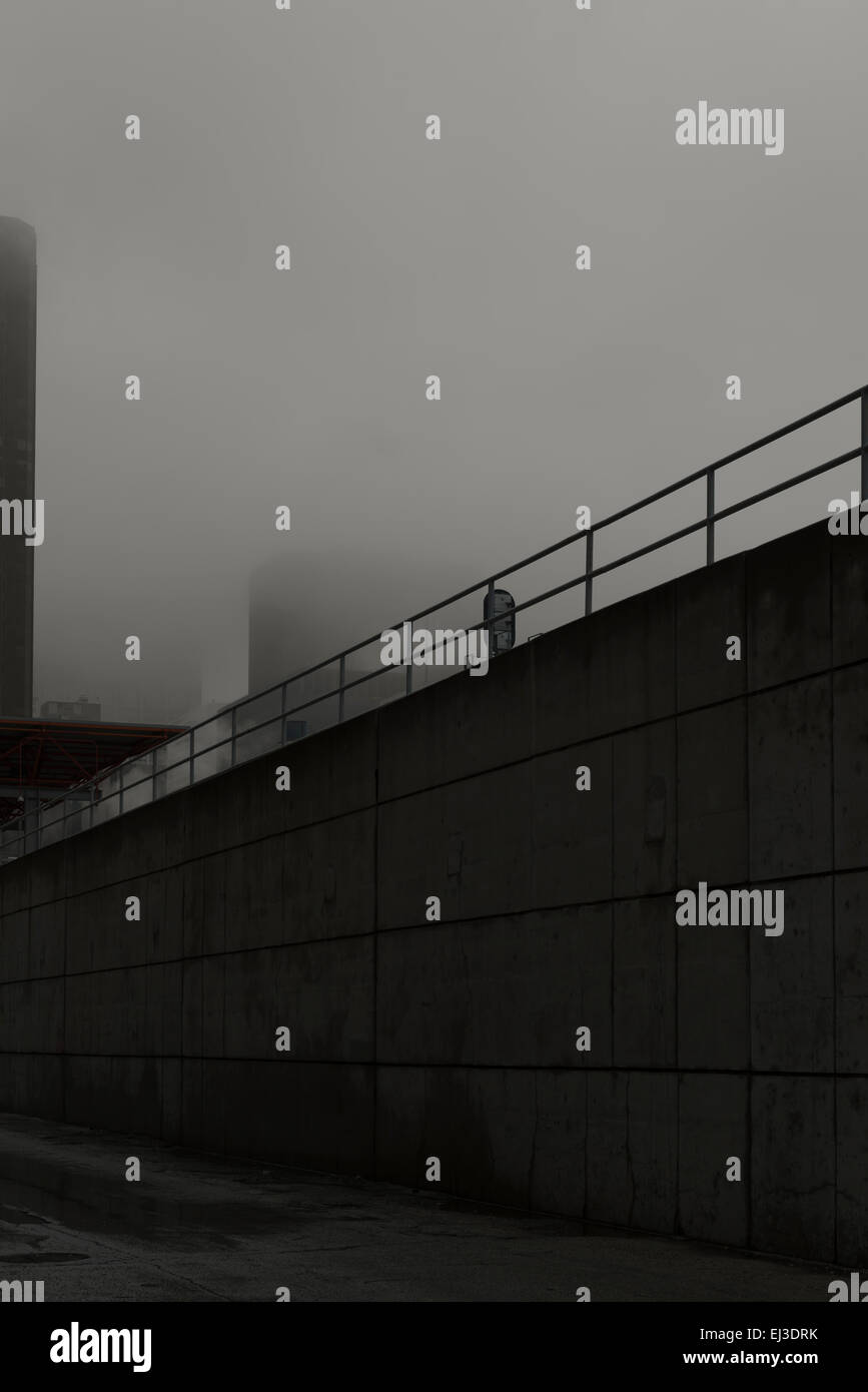 Foggy scene of alley behind train station Stock Photo