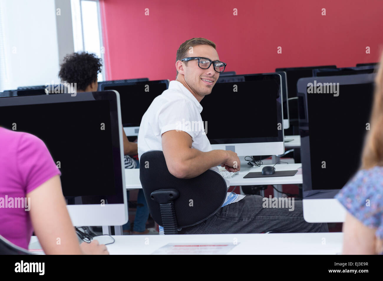 Student smiling at camera in computer class Stock Photo - Alamy