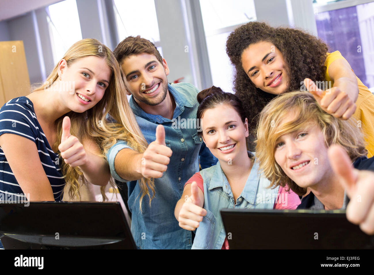 College students gesturing thumbs up Stock Photo - Alamy