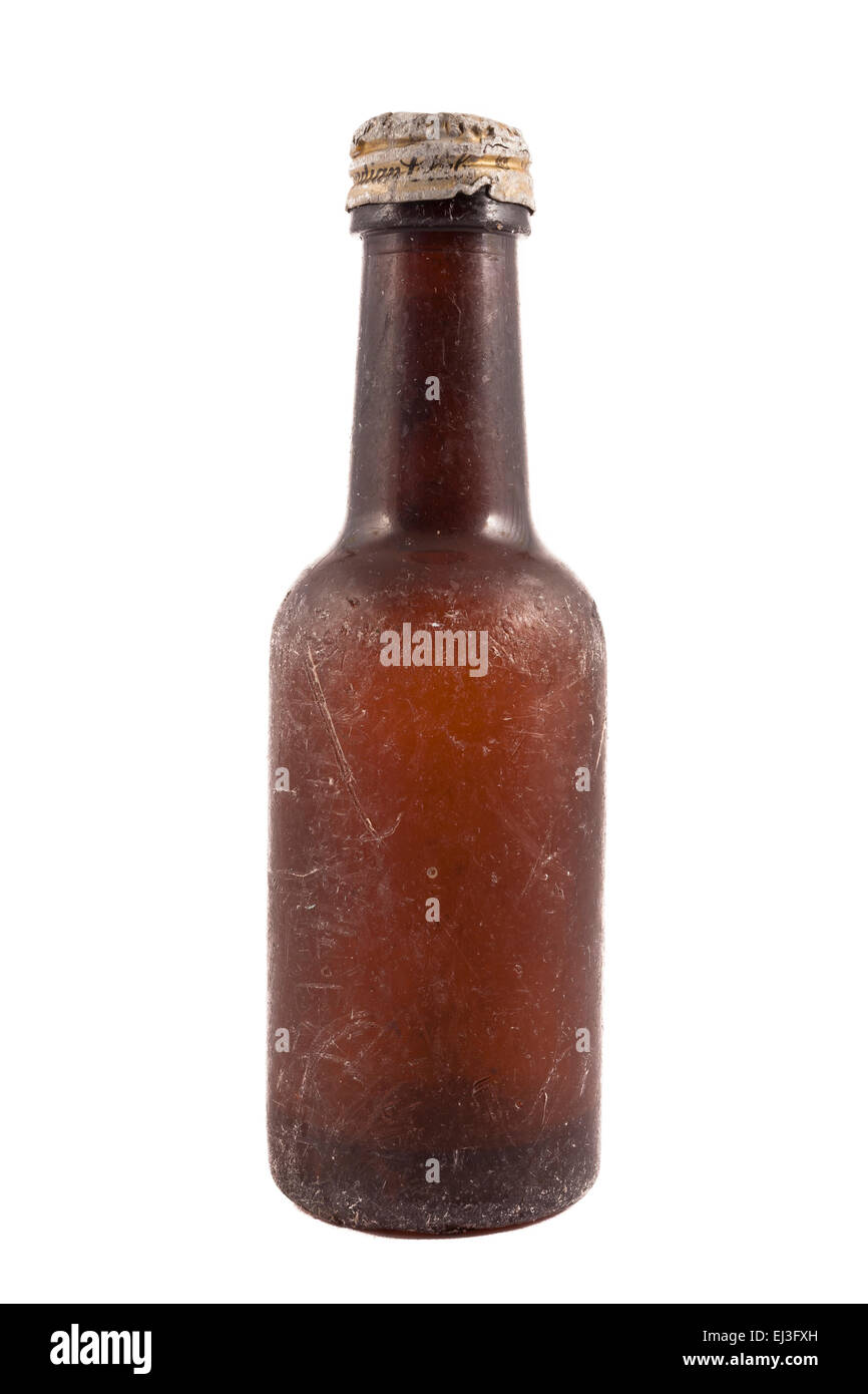 old brown scratched bottle isolated on white background with dented cap and liquid in bottom Stock Photo