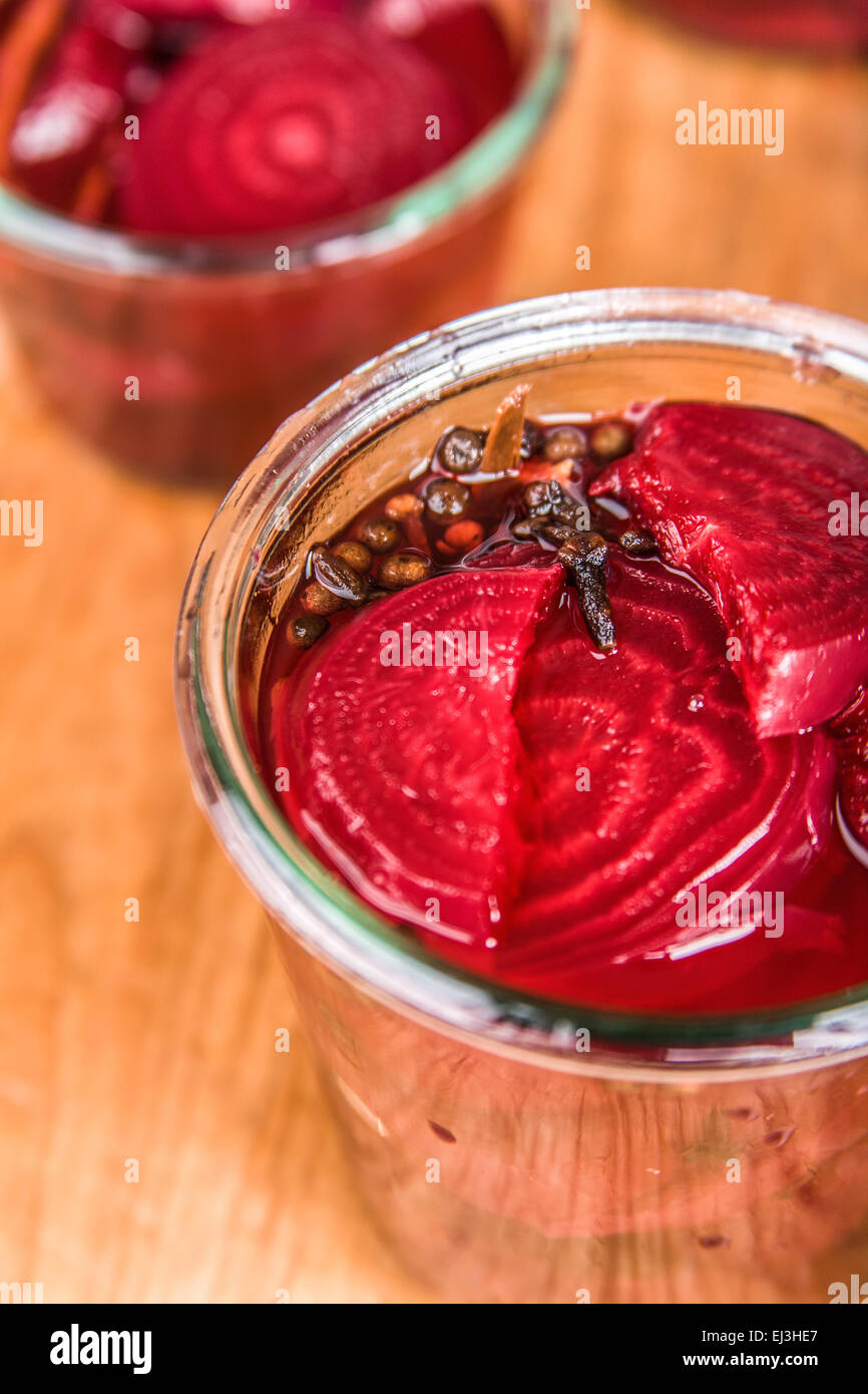 Jar of pickled beets with pickling solution in it, ready to have the lid put on and put into a hot water bath. Stock Photo