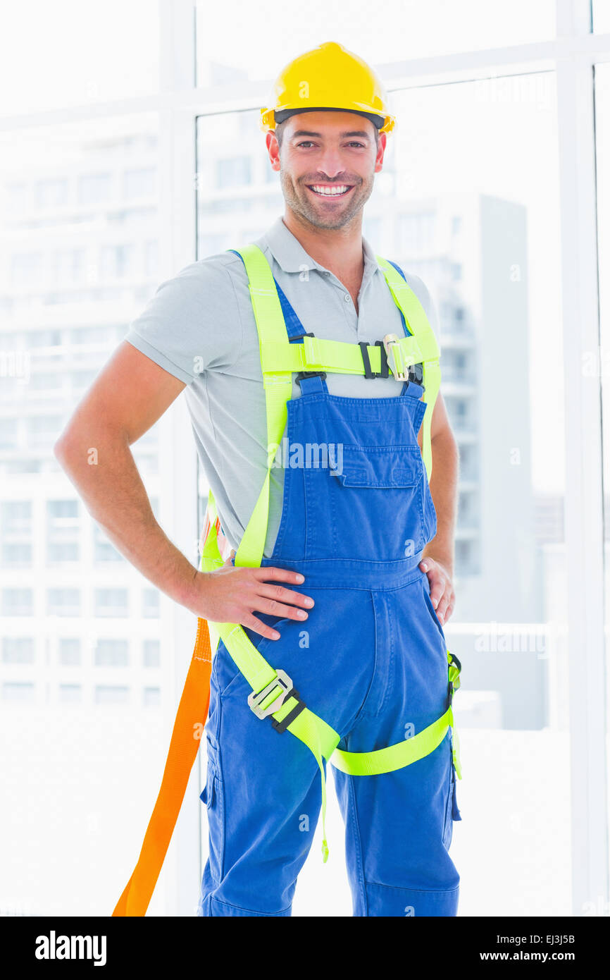 Construction worker wearing safety harness in office Stock Photo