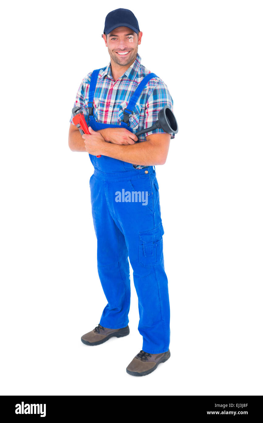 Male plumber holding plunger and wrench Stock Photo