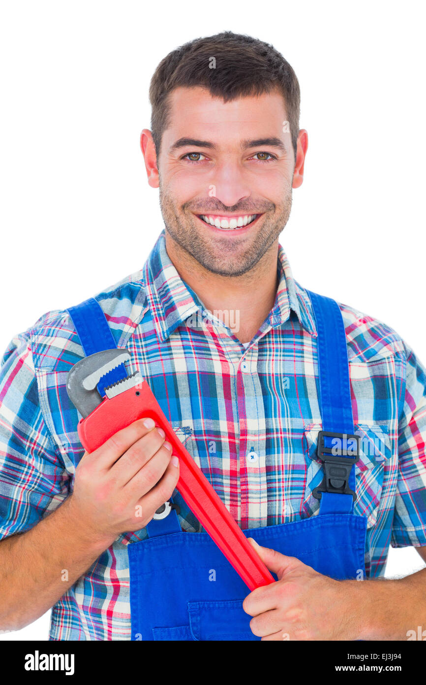 Confident male repairman holding monkey wrench Stock Photo