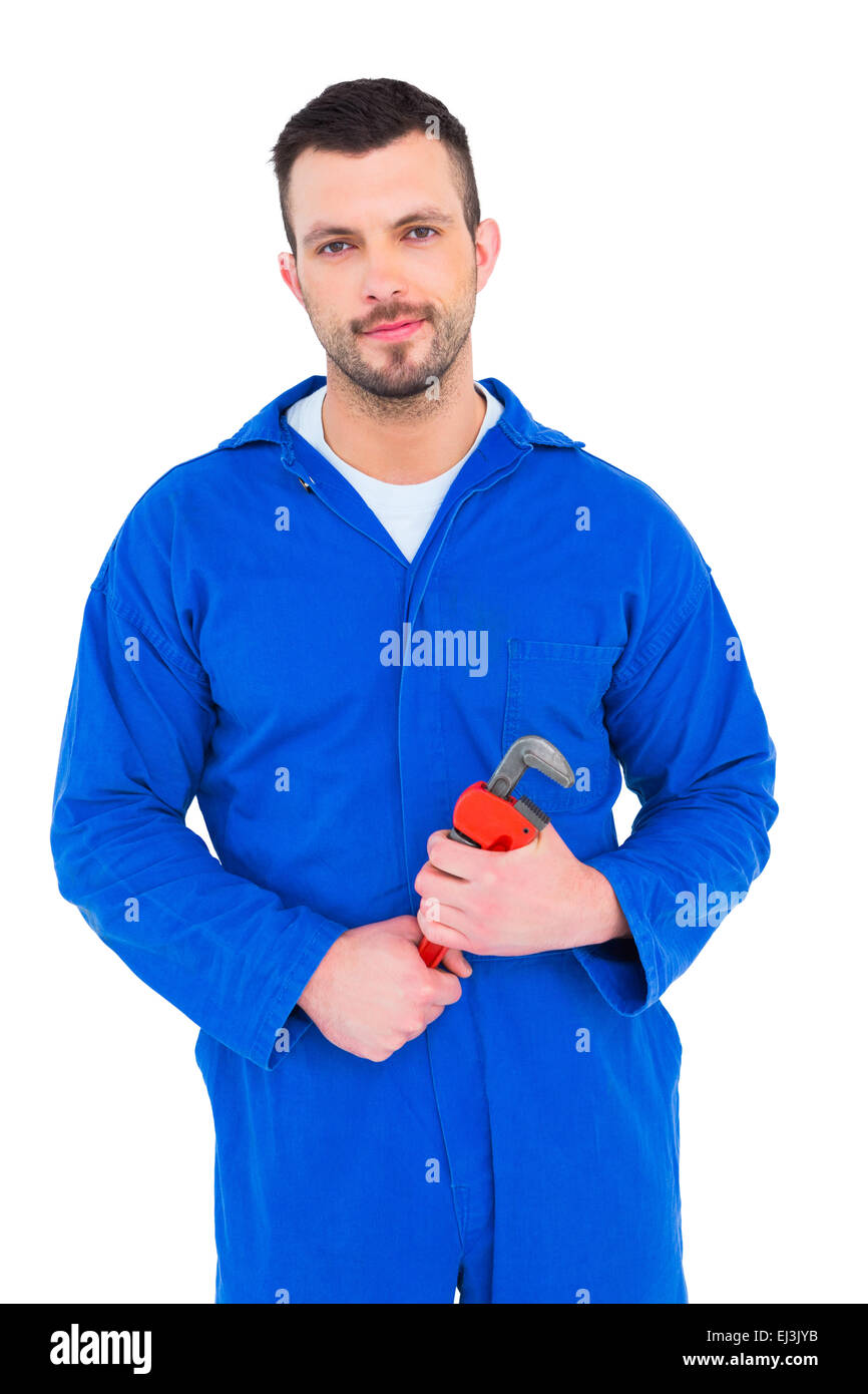 Smiling male mechanic holding monkey wrench Stock Photo