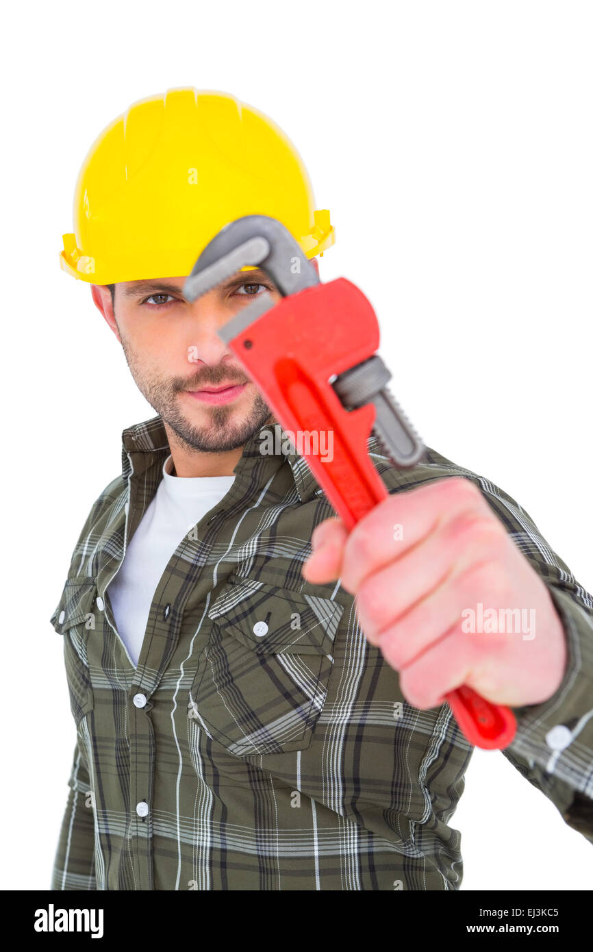 Manual worker looking through monkey wrench Stock Photo