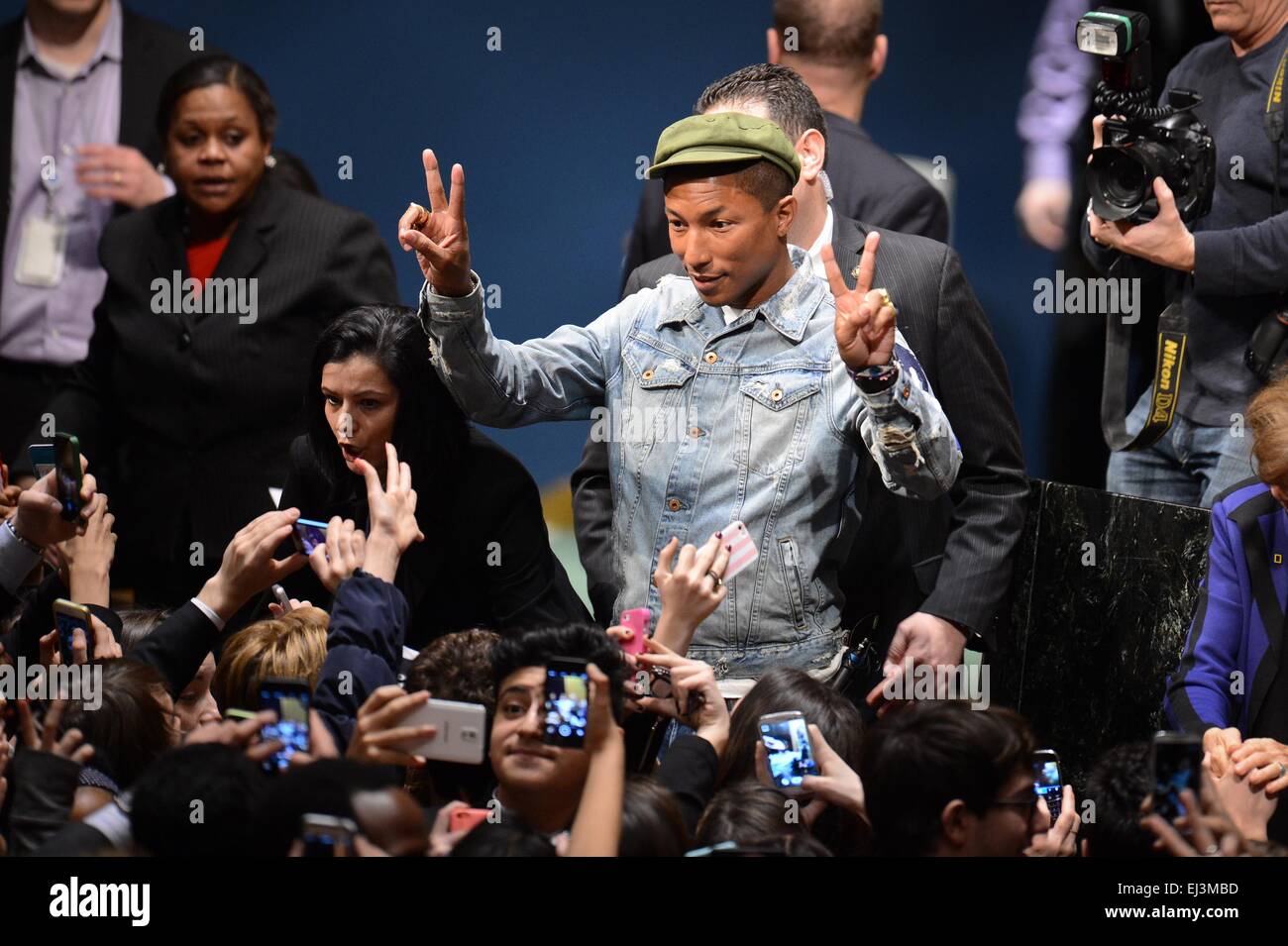 New York, USA. 20th Mar, 2015. Singer Pharrell Williams poses to fans during an event marking the International Day of Happiness at the UN headquarters in New York, on March 20, 2015. Grammy-winning singer Pharrell Williams joined the United Nations to celebrate the International Day of Happiness on Friday, with an emphasis on reaching out to young people and move them to take action on climate change. Credit:  Niu Xiaolei/Xinhua/Alamy Live News Stock Photo