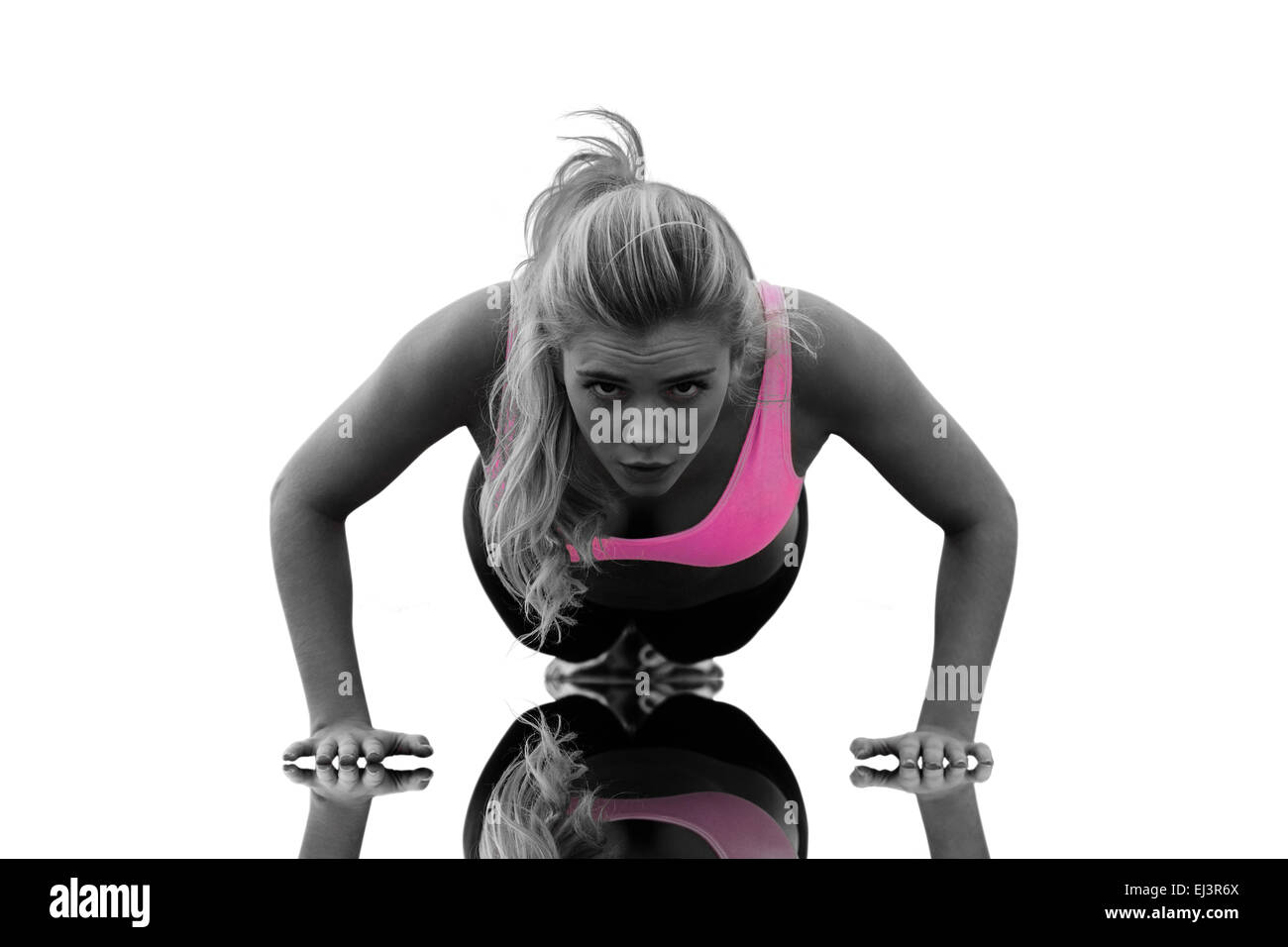 Composite image of beautiful woman doing push ups on beach Stock Photo
