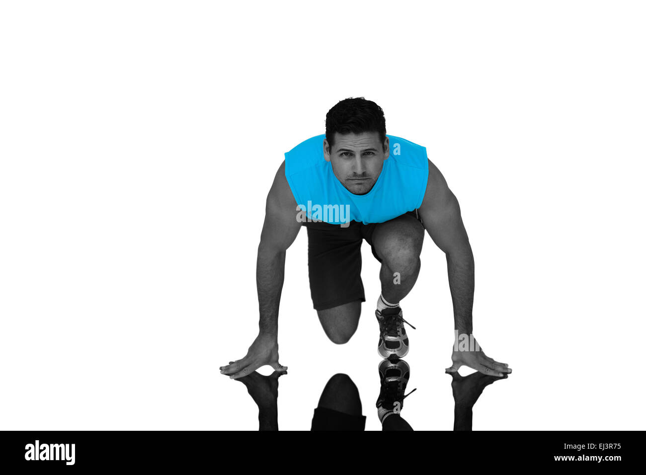 Composite image of portrait of a young sporty man in running stance Stock Photo