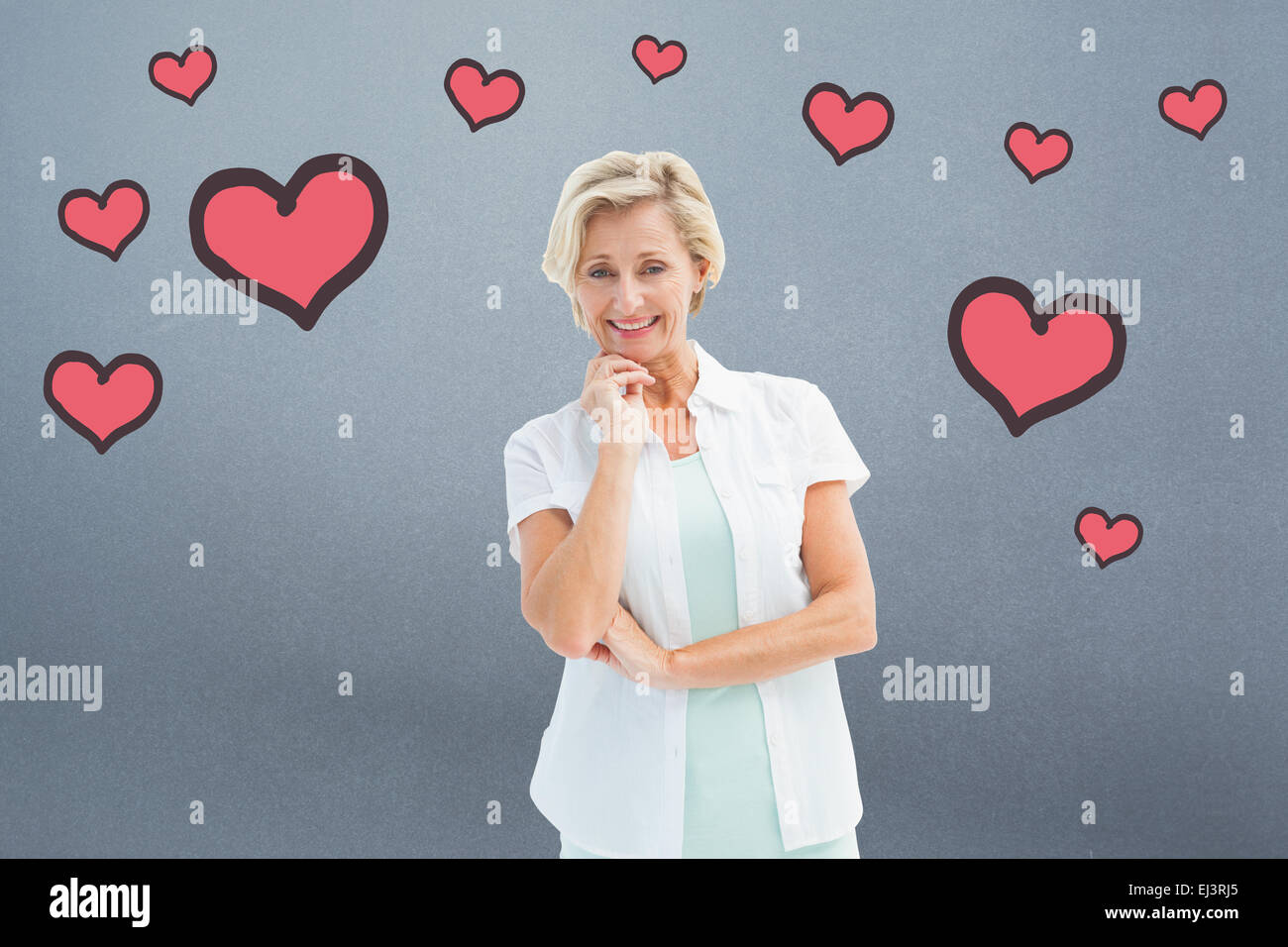 Composite image of happy mature woman smiling at camera Stock Photo