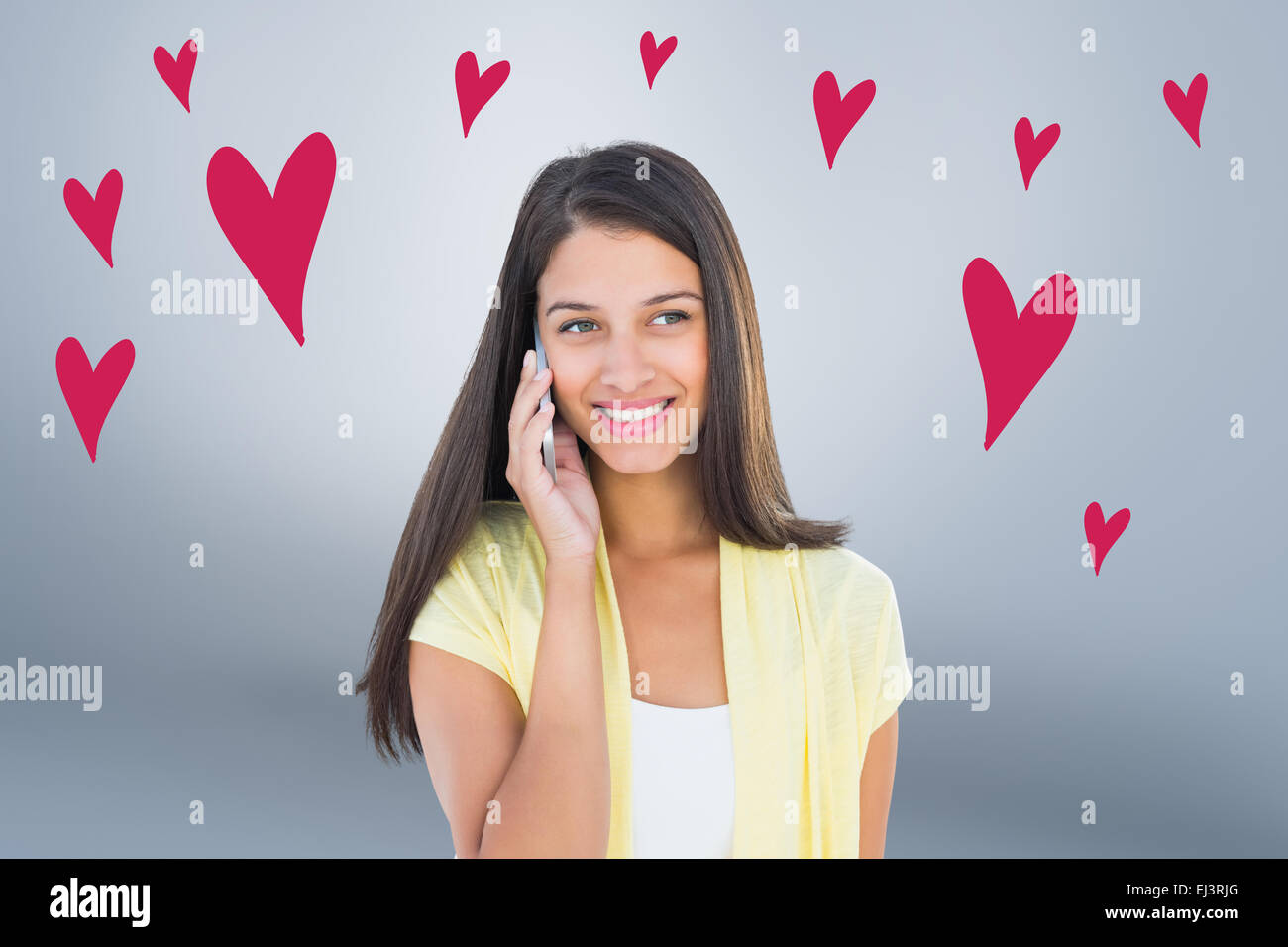 Composite image of happy casual woman on the phone Stock Photo