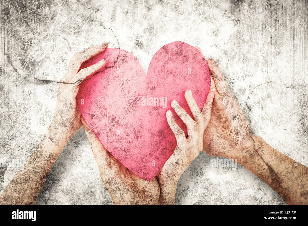 Composite image of couple holding a paper heart Stock Photo