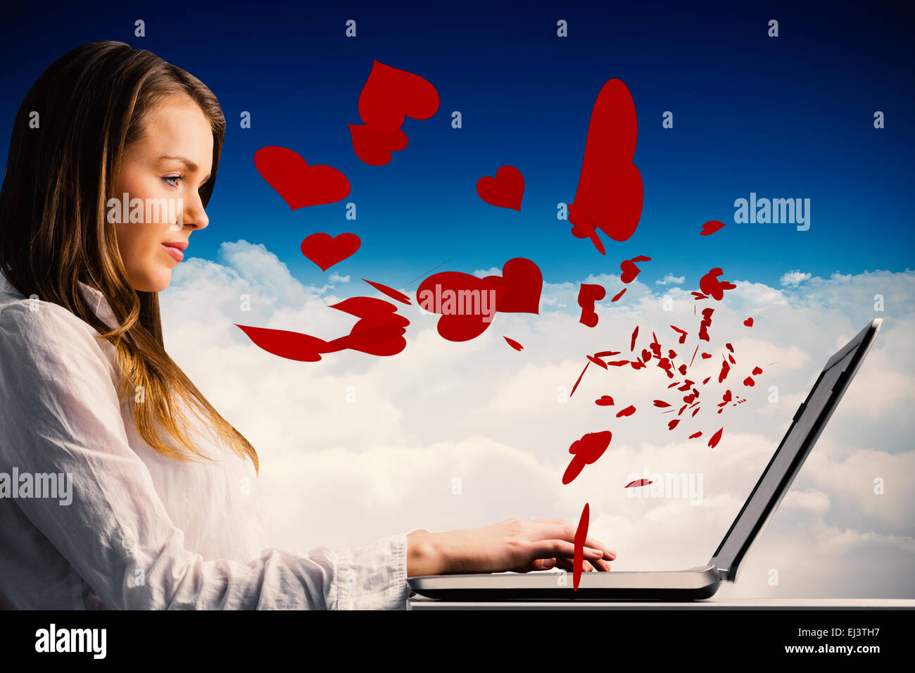 Composite image of businesswoman typing on her laptop Stock Photo