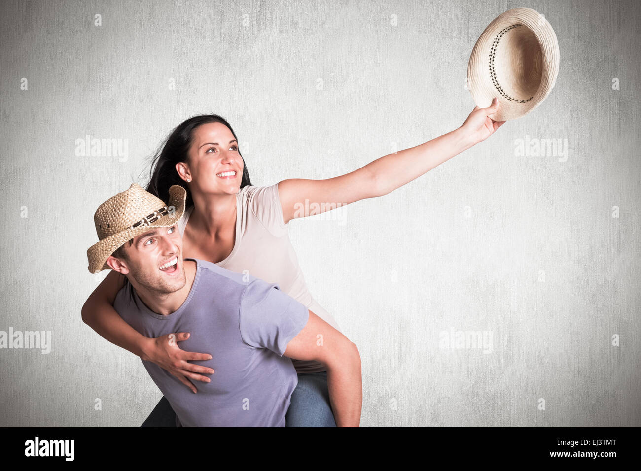 Composite image of man giving his pretty girlfriend a piggy back Stock Photo