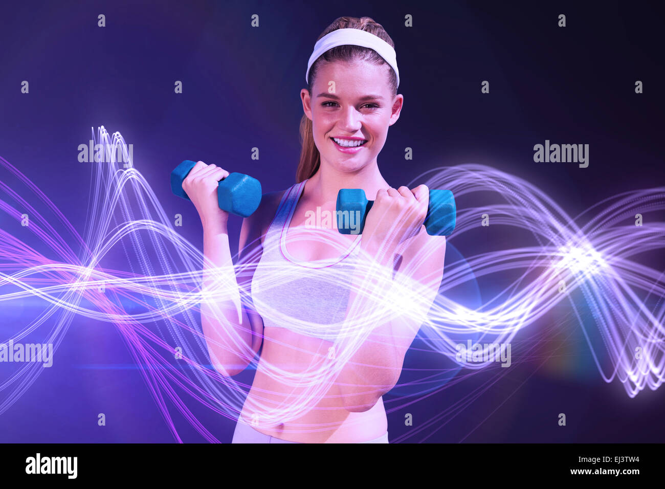 Composite image of sporty happy blonde lifting dumbbells Stock Photo