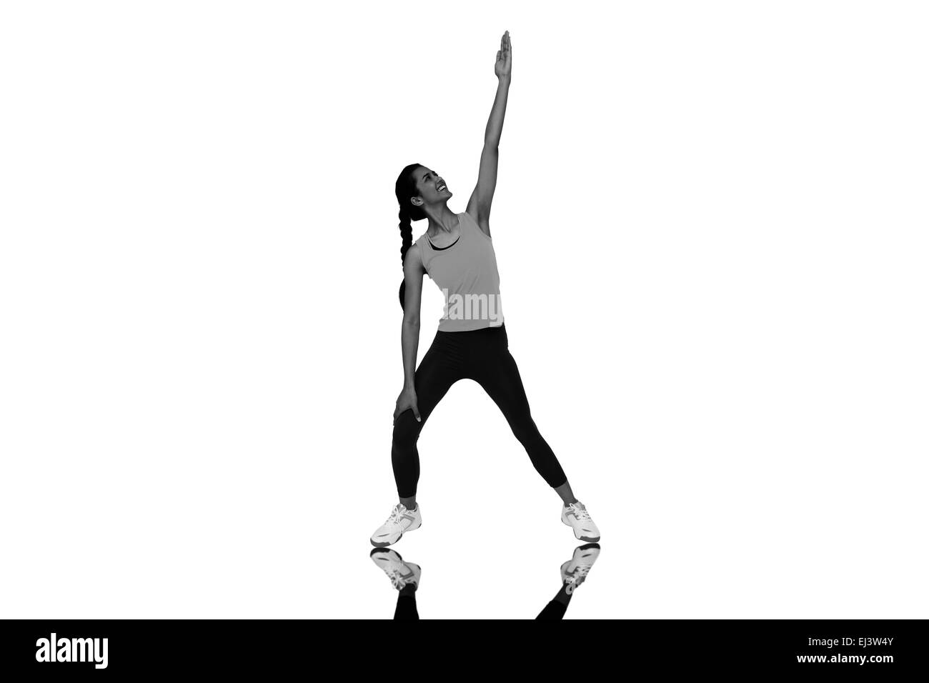 Composite image of full length of a sporty young woman stretching hand Stock Photo