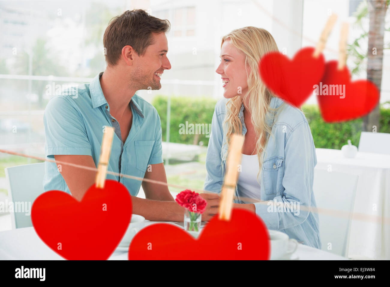 Composite image of hip young couple having desert and coffee together Stock Photo