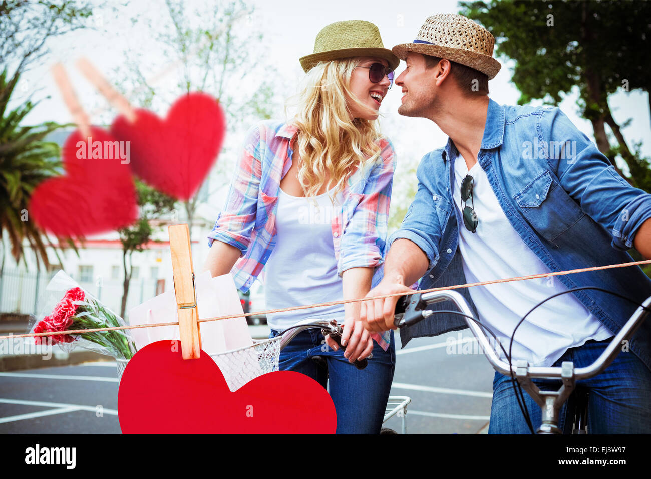 Composite image of hip young couple on a bike ride Stock Photo