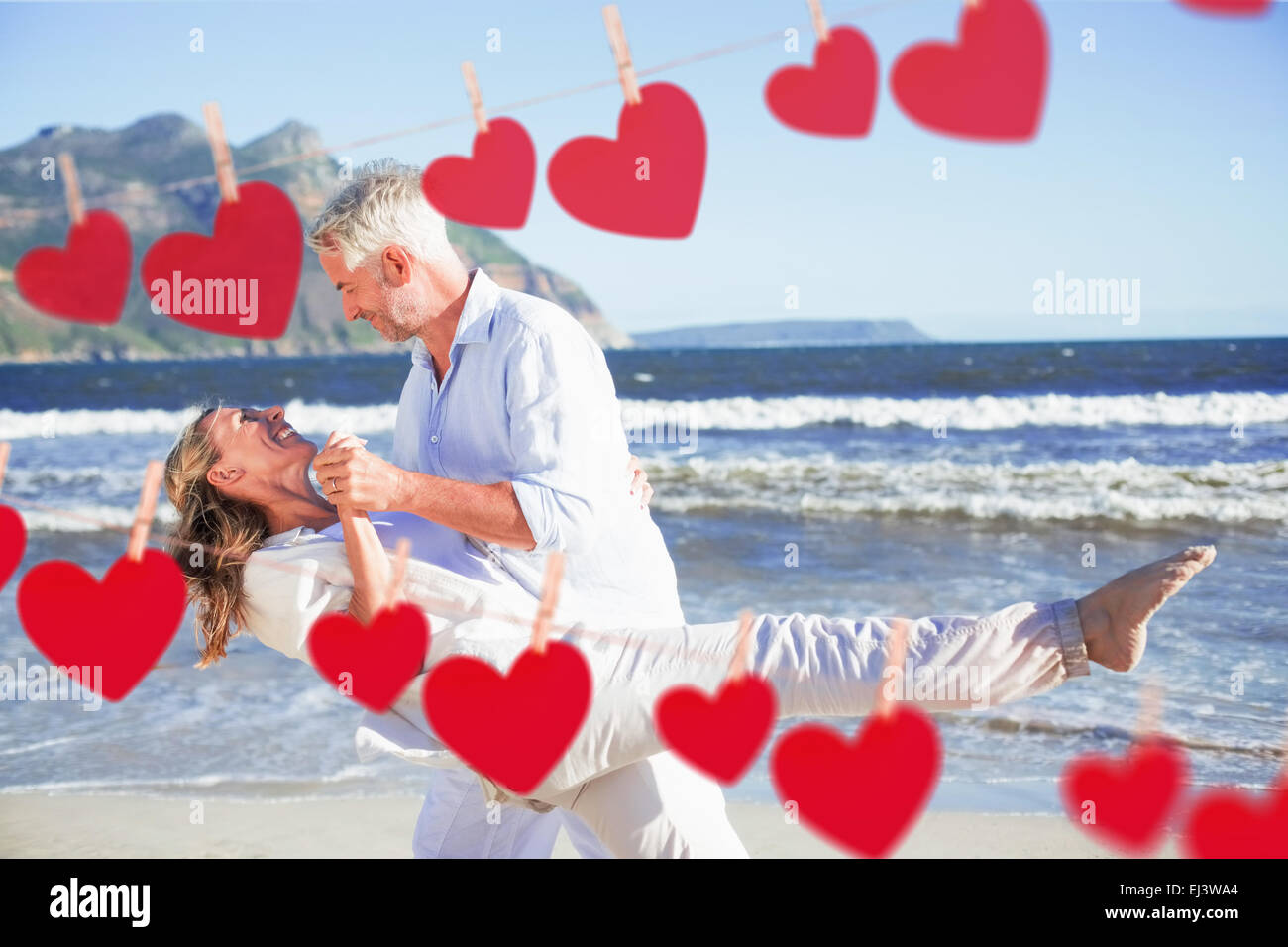 Composite image of happy couple dancing on the beach together Stock ...