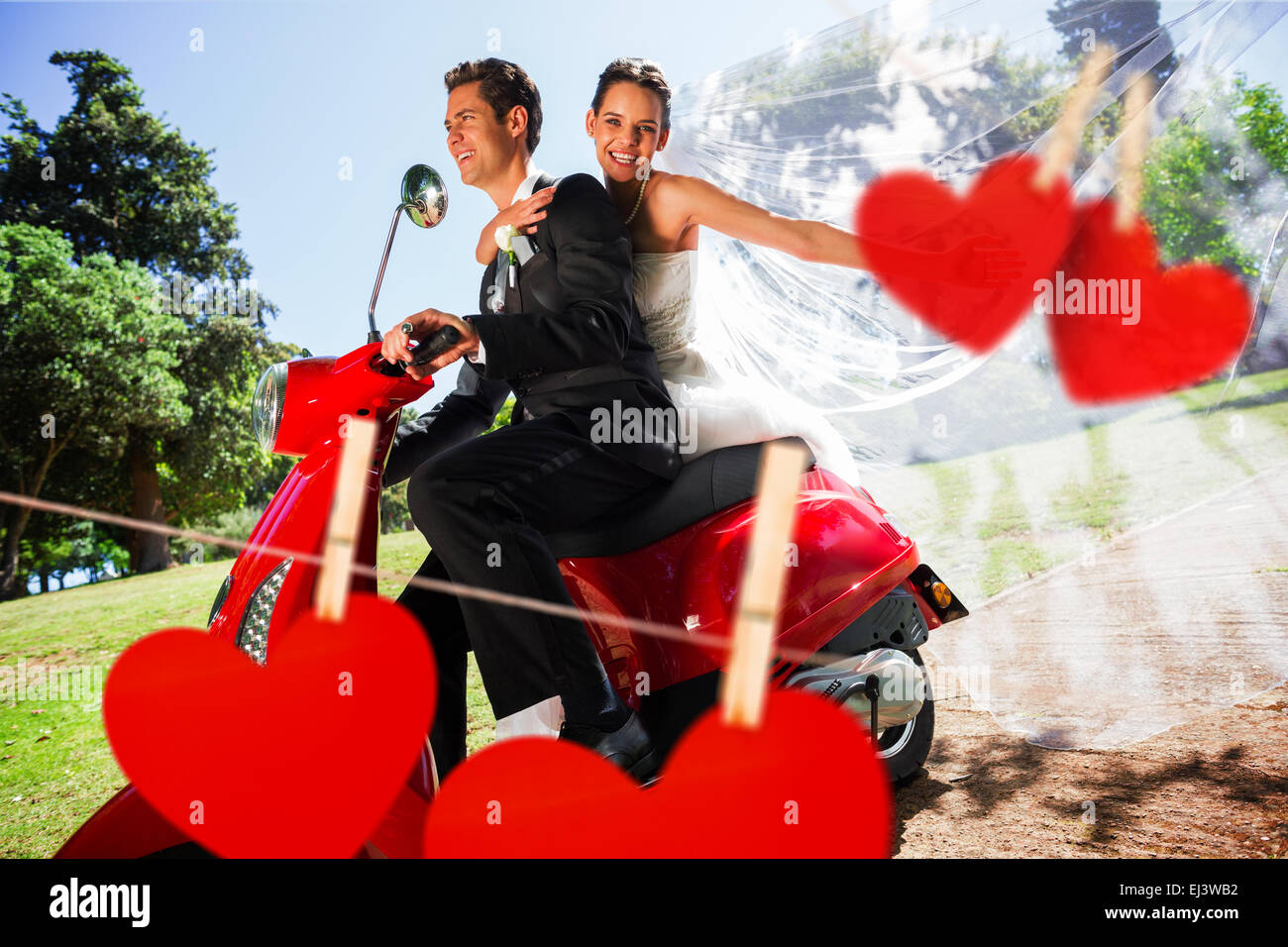 Composite image of newlywed couple enjoying scooter ride Stock Photo
