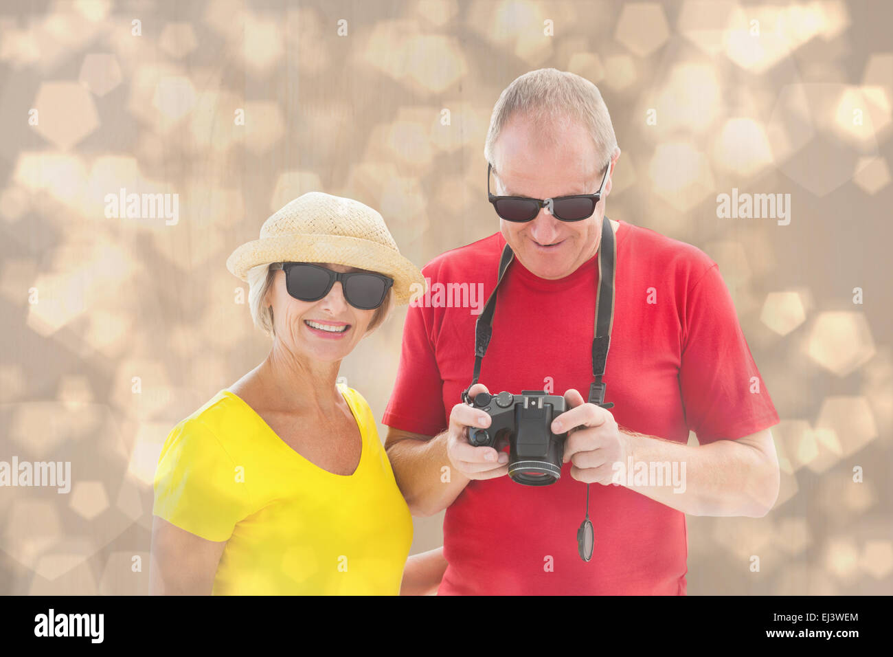 Composite image of happy mature couple wearing sunglasses Stock Photo