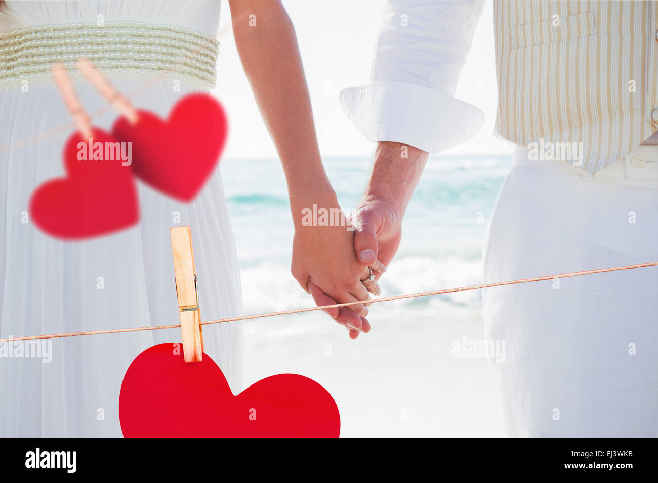 Composite image of newlyweds holding hands Stock Photo - Alamy