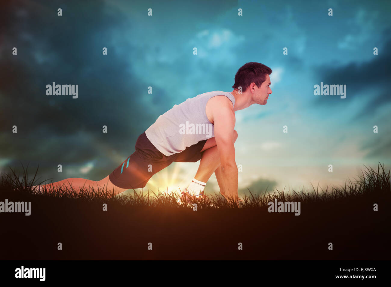 Composite image of side view of a young man in ready to run posture Stock Photo