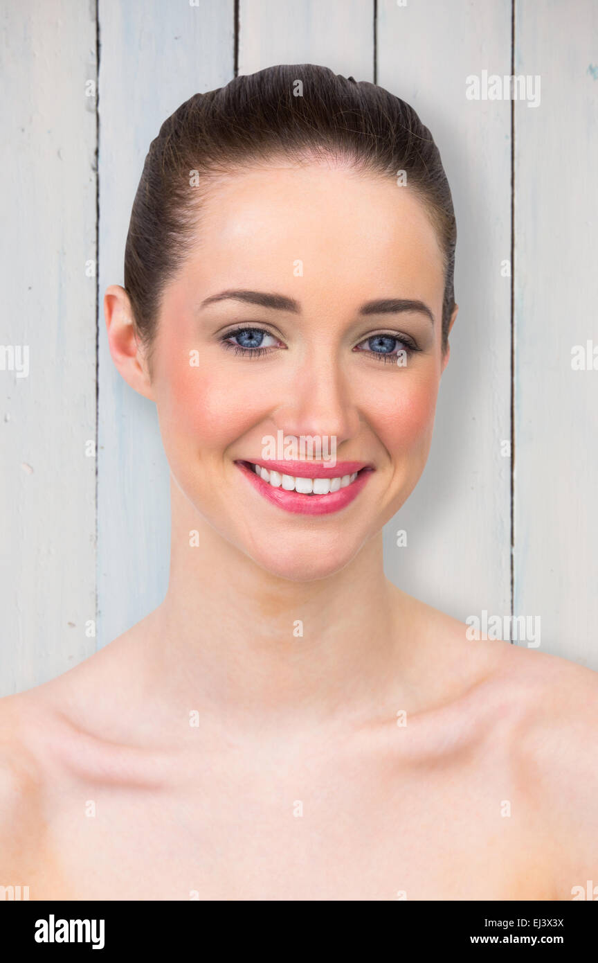 Composite image of beautiful brunette smiling at camera Stock Photo