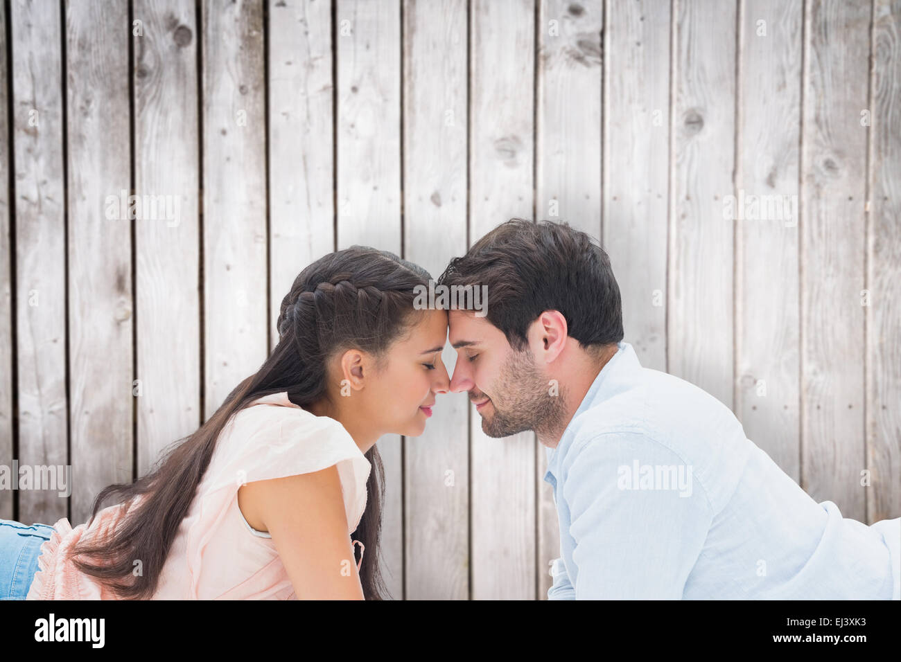 Composite image of attractive young couple smiling at each other Stock ...