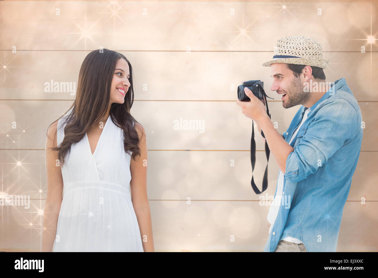 Composite image of handsome hipster taking a photo of pretty girlfriend Stock Photo