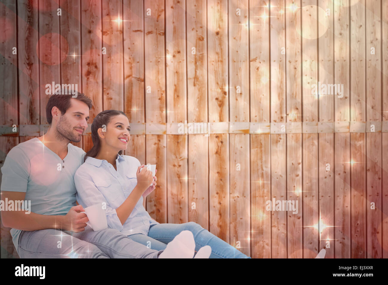 Composite image of cute couple sitting having coffee Stock Photo