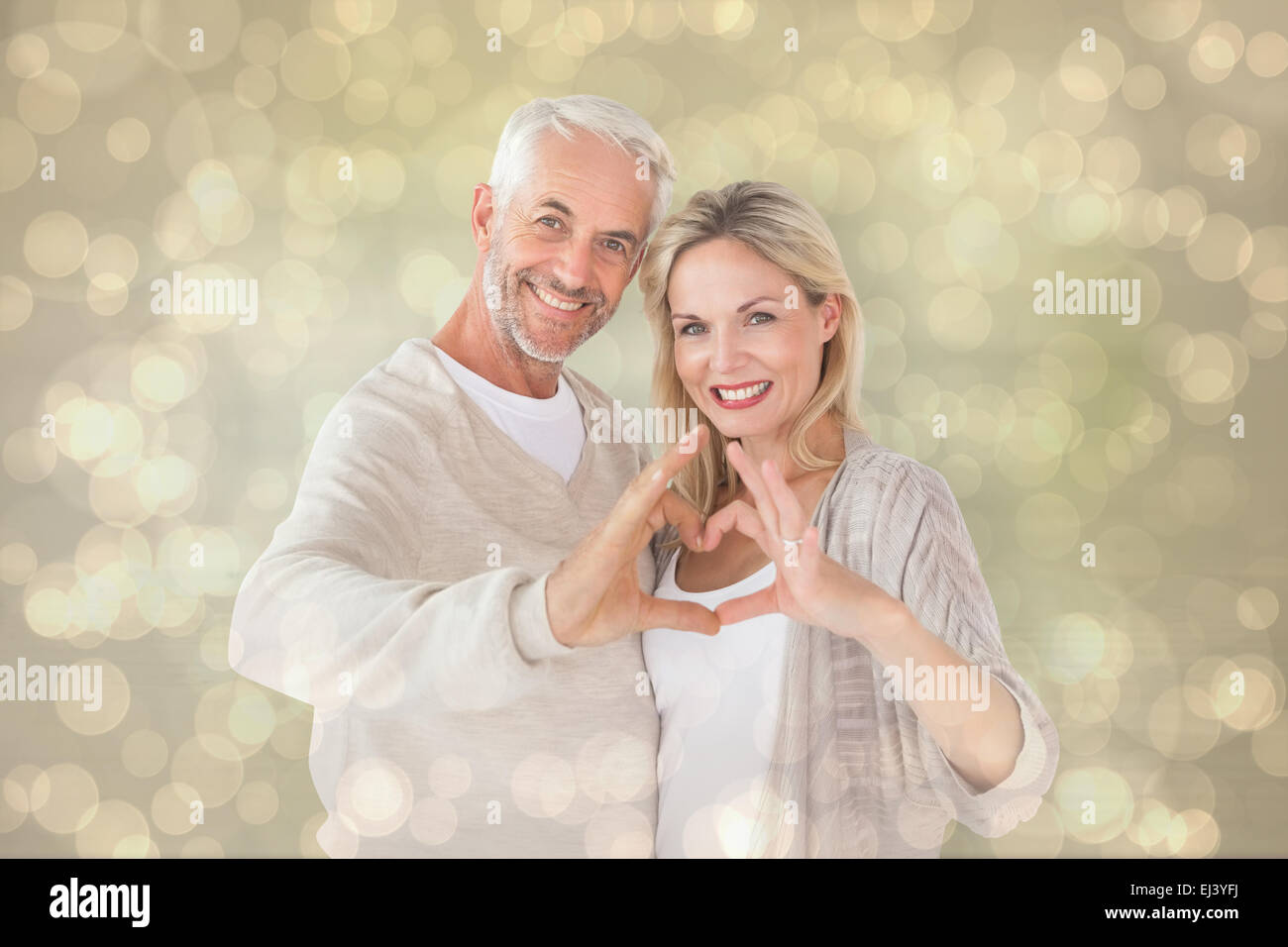 Composite image of happy couple forming heart shape with hands Stock ...