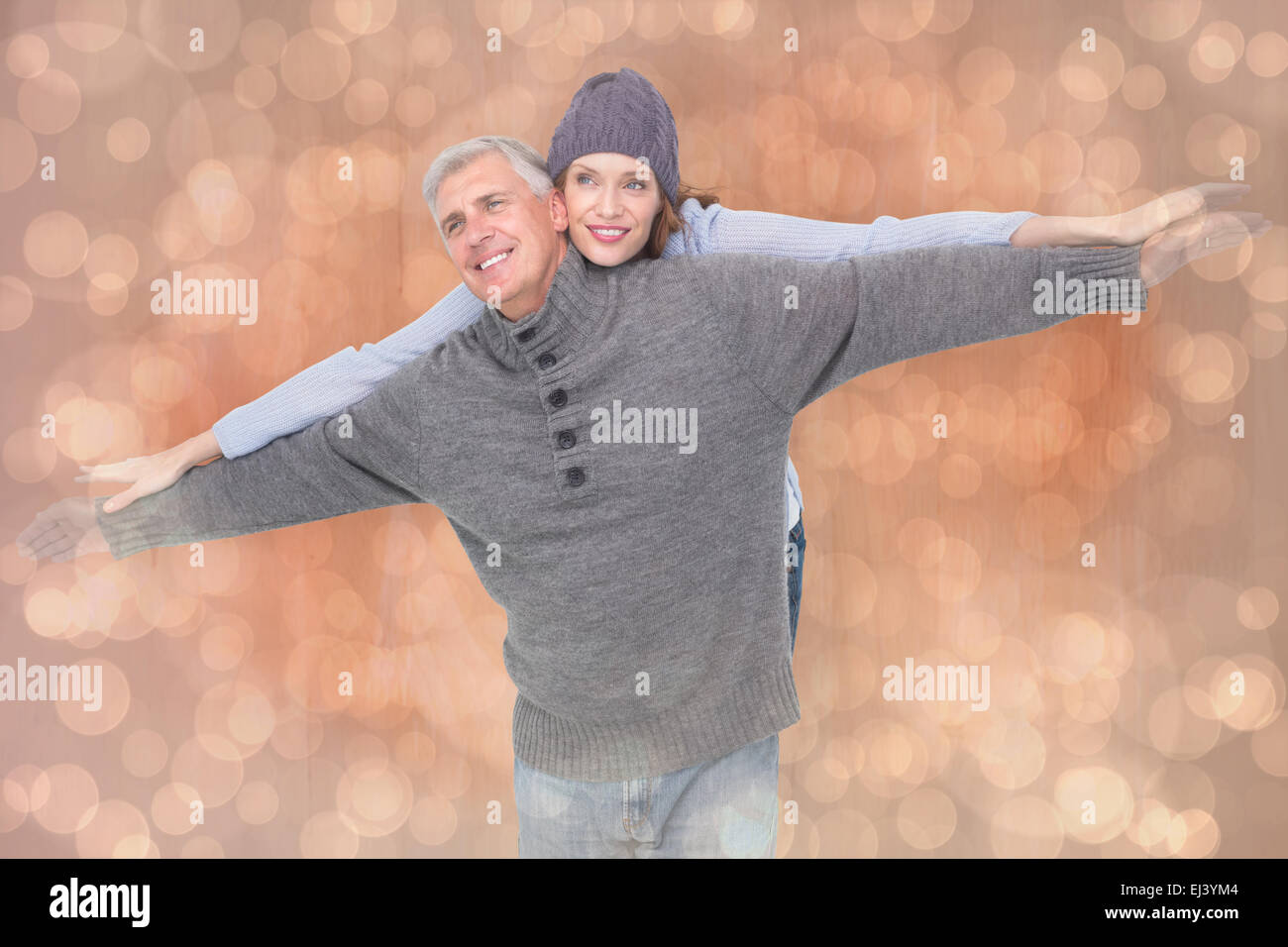 Composite image of carefree couple in warm clothing Stock Photo