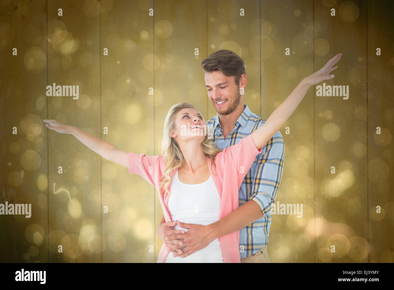 Composite image of attractive young couple smiling and embracing Stock Photo