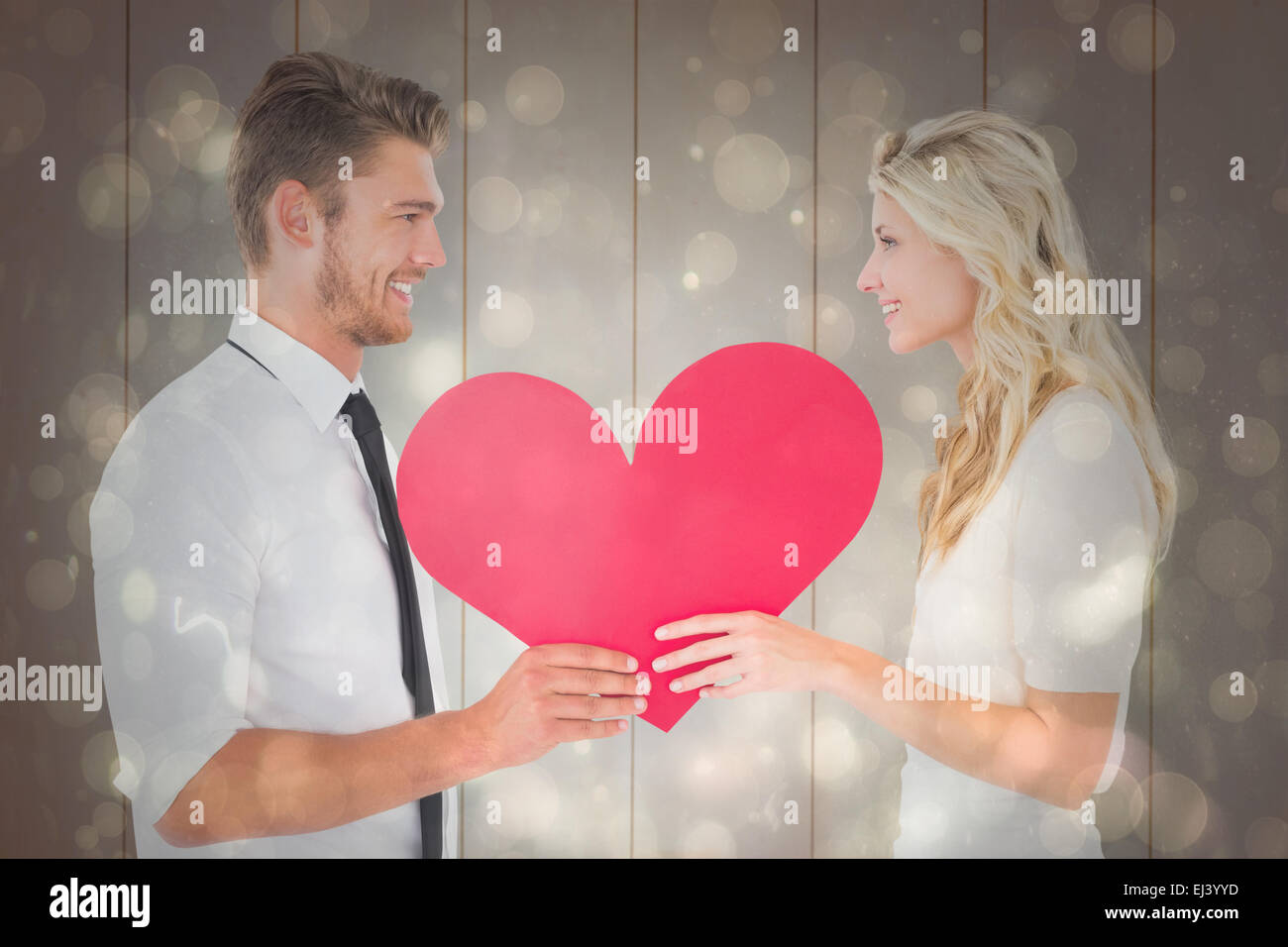 Composite image of attractive young couple holding red heart Stock ...