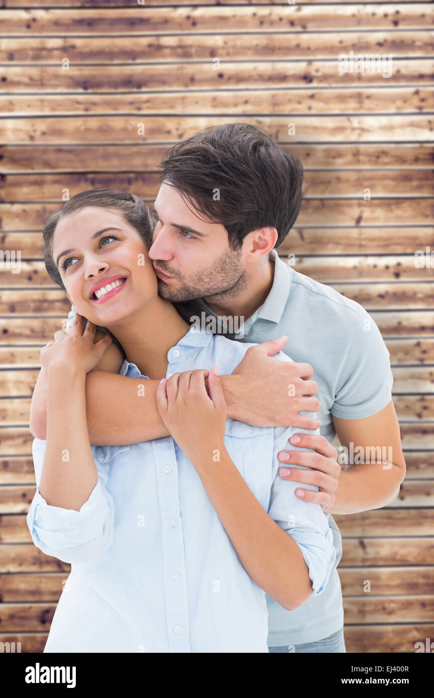 Composite image of cute couple hugging and smiling Stock Photo - Alamy