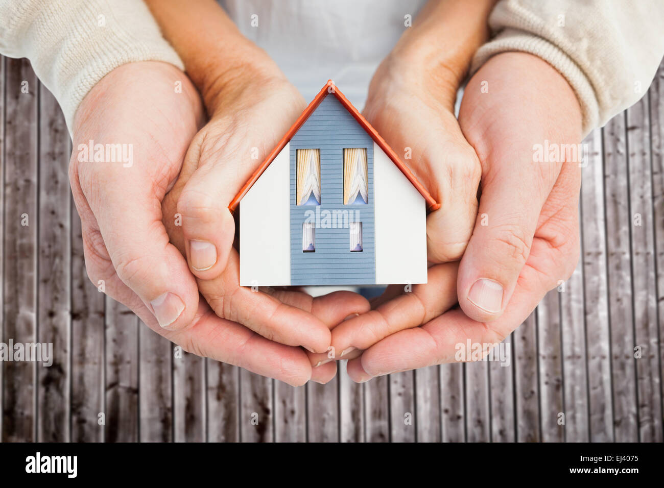 вложение денег в недвижимость. займ под недвижимость. деньги на дом. деревянный домик в руках. руки домиком.