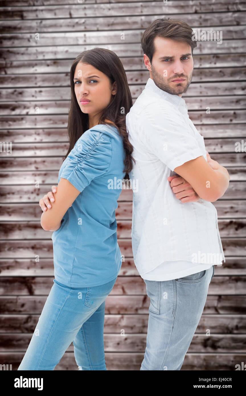 Composite image of upset couple not talking to each other after fight Stock Photo