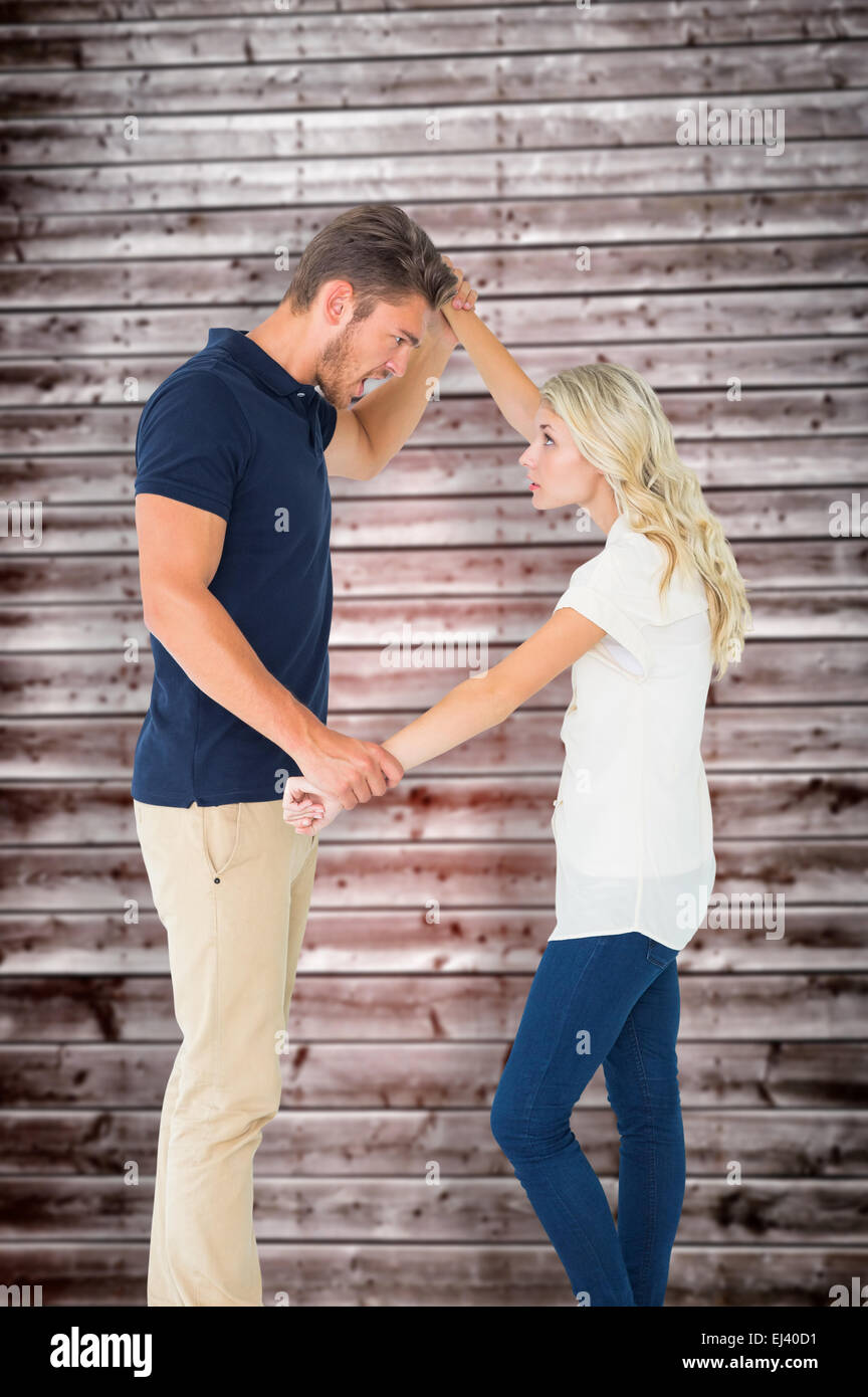 Composite image of angry man overpowering his girlfriend Stock Photo